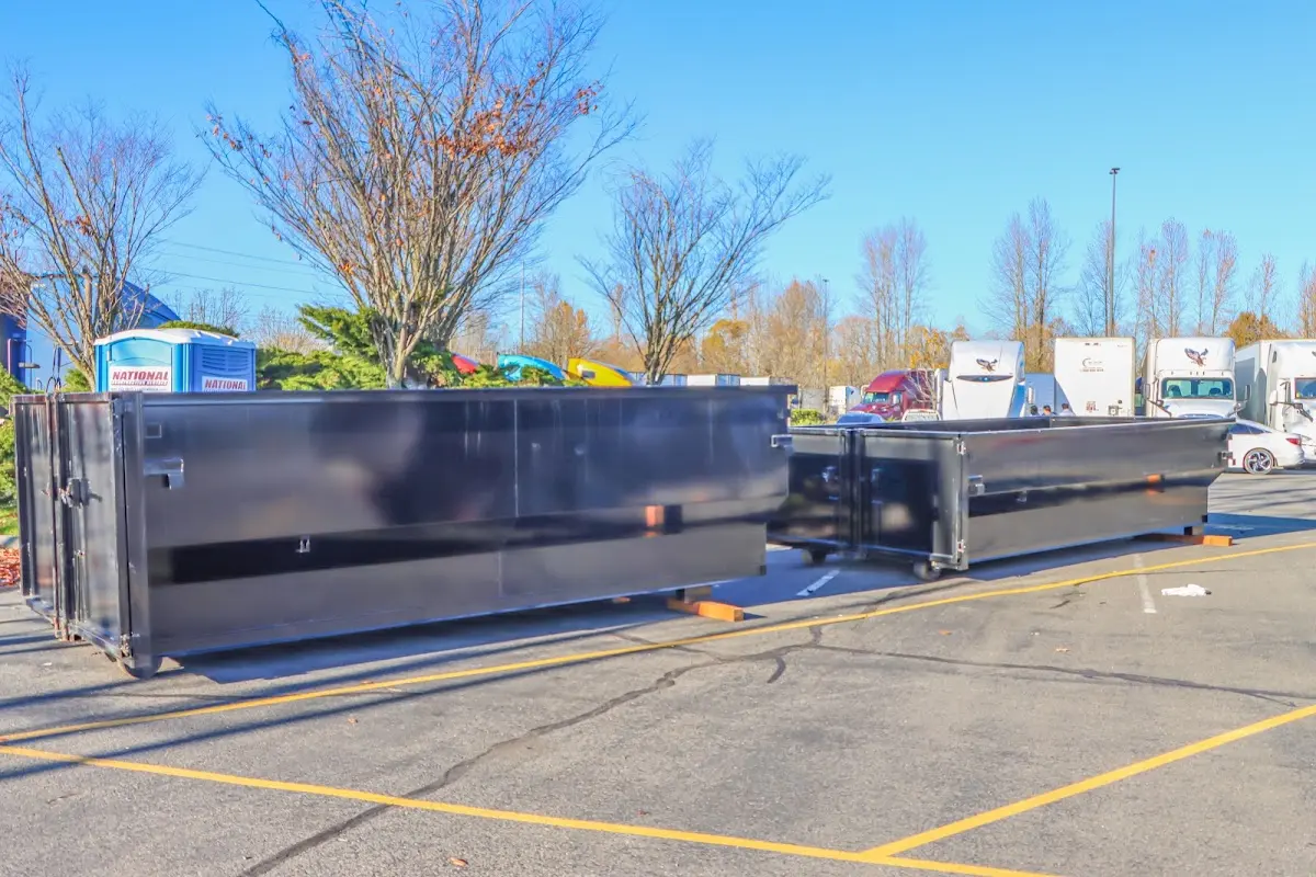 Professional dumpster rental service with roll-off container on residential driveway in Hinsdale